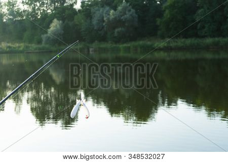 Carp Fishing On Beautiful Blue Lake With Carp Rods And Rod Pods In The Summer Morning. Fishing From 