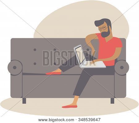 Young Man Using Laptop At Home Working As Freelancer