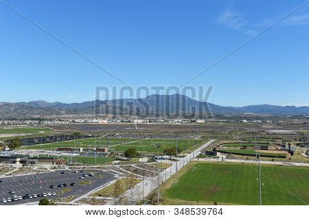 IRVINE, CALIFORNIA - 31 JAN 2020: Aerial view of the Soccer Stadium, Softball Stadium and Tennis Facility with Saddleback peak. 