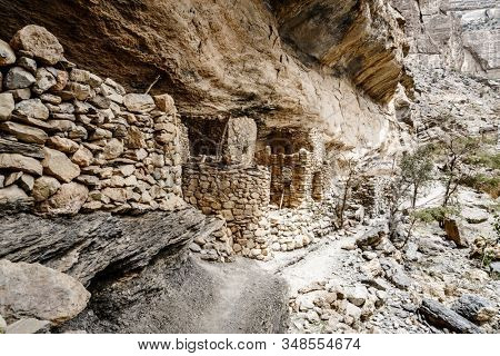 Ancient stone cliff dwellings in Wadi Ghul in Oman