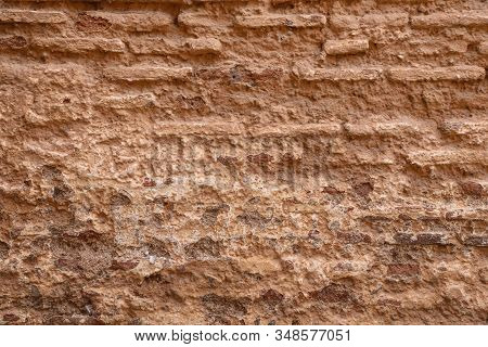 Crumbling Texture Of An Old Brown Mud Brick Wall