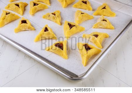 Raw Hamentaschen Cookies With Chocolate Chips On Baking Tray For Jewish Holiday Purim.