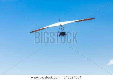 Extremal Air Sports Competition - Hang Gliding. Overhead View Of The Soaring Hang Gliding Pilot Agai