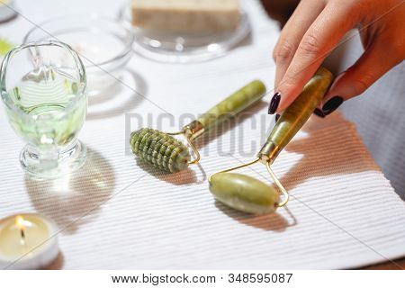 Woman Using New Massager For Facebuilding Indoors