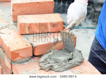 Bricklayers Hands In Masonry Gloves Bricklaying New House Wall. Bricklaying House Wall