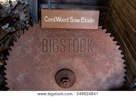An Old And Grungy Cordwood Saw Blade. An Old Rustic Wood-cutting Wheel. Industrial Vintage Equipment