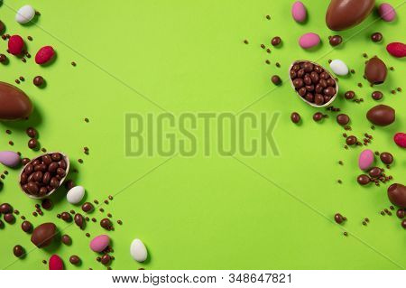 Egg Hunt Is Coming. Easter Traditions, Chocolate Eggs, Candies On Green Background, Top View, Copysp