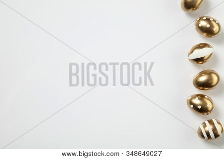 Egg Hunt Is Coming. Easter Traditions, Golden Colored Eggs On White Background, Top View, Copyspace 