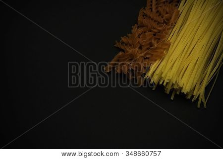 Different Spaghetti On Black Background. Top View. Pasta.