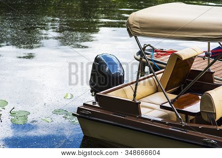 Small Motor Boat At Anchor By Rope In Replot Pier
