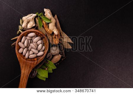 Natural Medicine Concept. Herbal Tablets In A Wooden Serving Spoon Or Spatula With Different Spices 