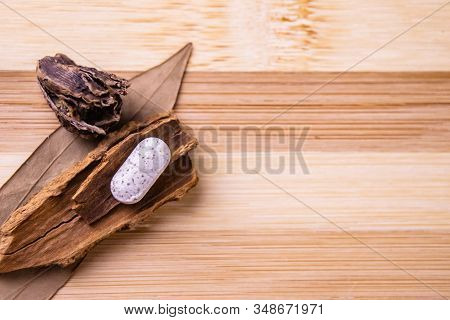 Traditional Medicine Concept. Top View Of White Ayurvedic Tablet With Cinnamon, Black Cardamom And B