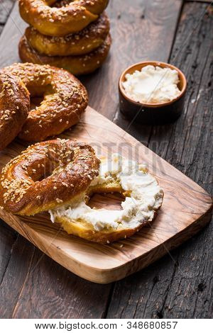 Bagels Sandwich With Cream Cheese On Wooden Table. Bagel. Heap Of Fresh Baked Bagels On Concrete Bac