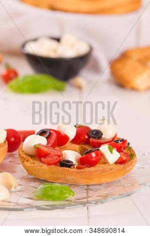 Friselle With Tomatoes And Mozzarella Cheese On Wooden Table.