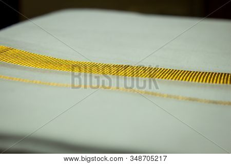 Close View Of The Dhoti With Gold Threaded Border. Dhoti Is A Traditional South Indian Dress Wore By