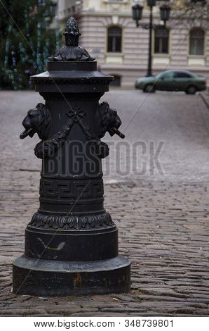 Riga, Latvia. Road Pillar With Lions Heads At Torna Street In Old Town.