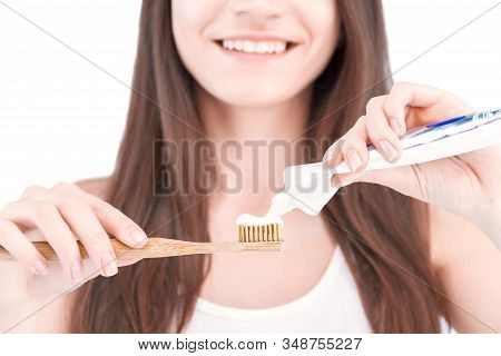 Closeup Female Hand Is Holding Ecological Bamboo Brush. Smiling Young Woman Is Squeezing Paste From 