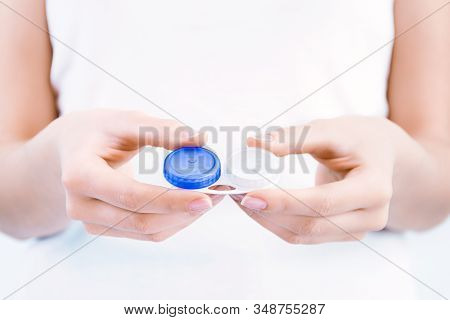 Closeup Female Hands Are Holding Container For Transparent Soft Contact Lens. Young Woman Is Prepari