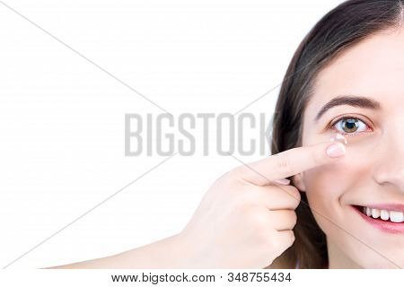 Closeup Female Face, Finger Is
Holding Soft Contact Lens. Woman Is Going To Insert Lenses. Tool For 