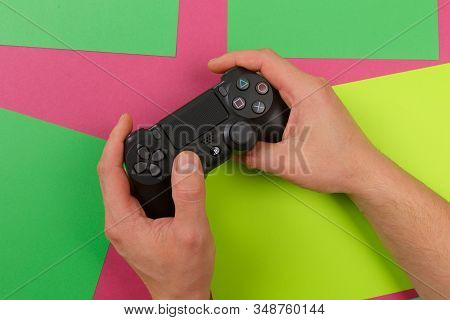 Russia, Oktober 24 2019: Male Hands Holding A Ps4 Controller, Sony Playstation 4 Game Console.
