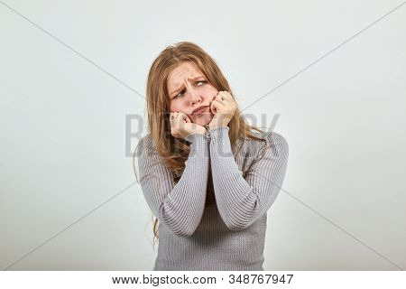 A Young Beautiful Red Haired Woman In Gray Sweater With Bad Mood Ruefully Disappointedly Propping He