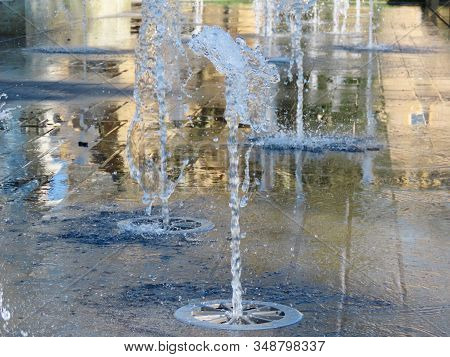 Fountain In City Park, Many Jets Of Water Shooting Up At Different Heights And Intervals Like A Geys