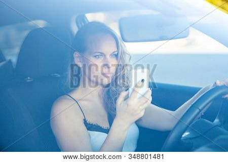 woman texting and talking on cellphone or mobile phone
