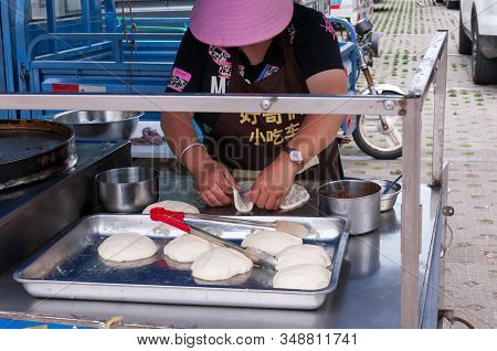 China, Heihe, July 2019: A Woman Prepares Tortillas At A Street Market In Heihe In The Summer