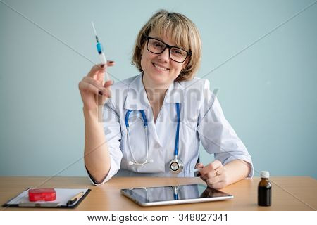 Doctor With Syringe In Hands Close Up.