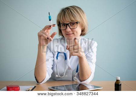 Doctor With Syringe In Hands Close Up.