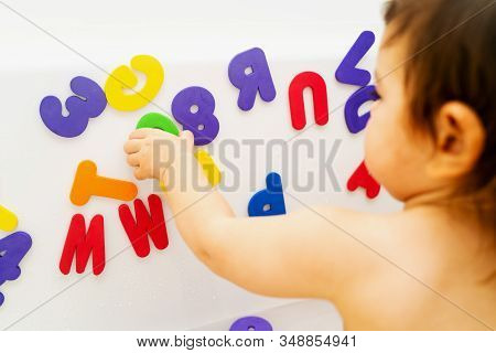 Little Girl Is Playing Foam Lettern In The Bath. Learning Abc With Play. Montessori Activity