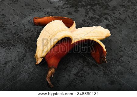 Red Bananas On A Dark Background. Red Bananas Are Shorter, A Kind Of Banana. Brown Banana Variety.
