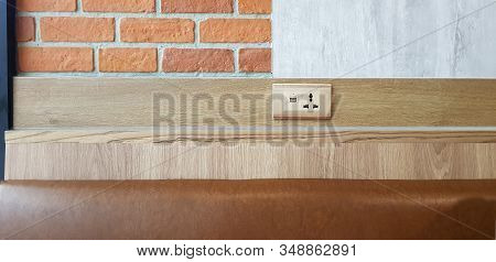 Ac Power Plug Outlet And Usb On The Wooden Wall,outlet Power Saving Hand Inserting Electrical Plug I