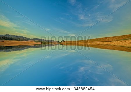 A Lake In The Mountain Under The Blue Sky