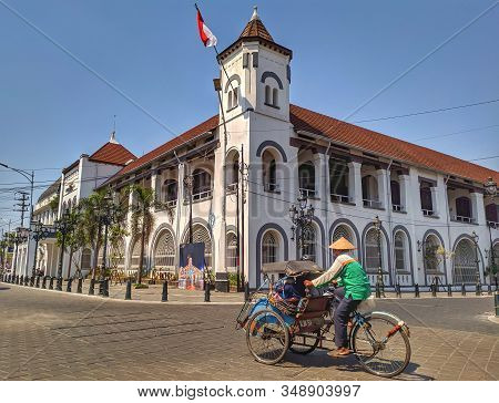 Semarang, Indonesia - 05 October 2019: Pedicab Drivers - Pedicabs Are Passing An Old Building In The