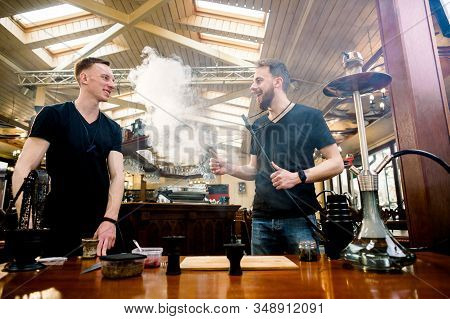 Two Masters Barmen Prepare Hookah Sisha In Hookah Bar. Tabaco Preparation.