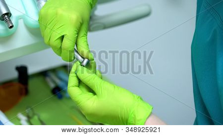 Stomatologist Puts On Tip On Handpiece Professional Equipment In Modern Clinic