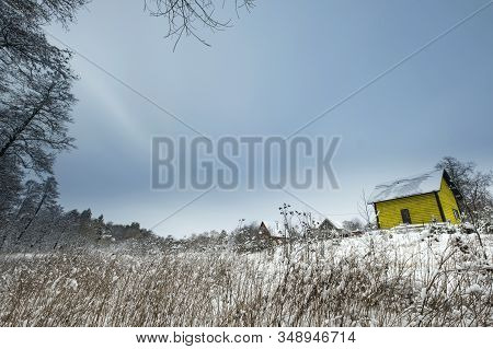 Blue Sky With Snow Field And Yellow House. Great Background With Copyspace. Winter And Snow Landscap