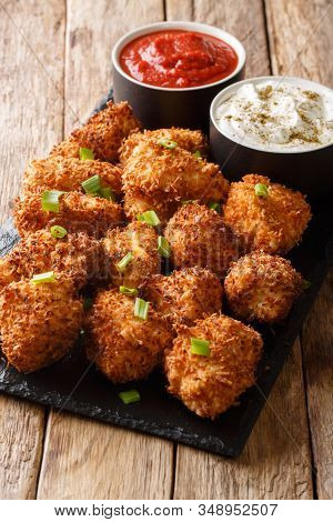 Crispy Coconut Chicken Nuggets Served With Ketchup And Mayonnaise Close-up On A Table. Vertical