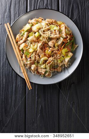 Delicious Filipino Food Pancit Bihon Rice Noodles With Vegetables And Meat Close-up In A Plate. Vert