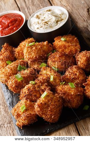 Deep-fried Coconut Breaded Chicken With Two Sauces Close-up On A Slate Board. Vertical