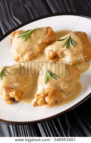 Holy Yum Chicken Thighs In Mustard Maple Sauce Close-up In A Plate. Vertical