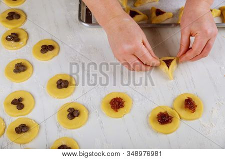 Woman Making Hamentaschen Cookies With Jam And Chocolate Chips For Purim. Jewish Holiday Concept,