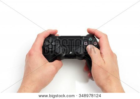 Russia, Oktober 24 2019: Mans Hands Holding  New Sony Dualshock 4 With Playstation 4. Sony Playstati