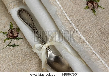 Vintage Russian Silverspoon With Silk Ribbon On Linen Napkin. Old Fashion Heroloom Silverware