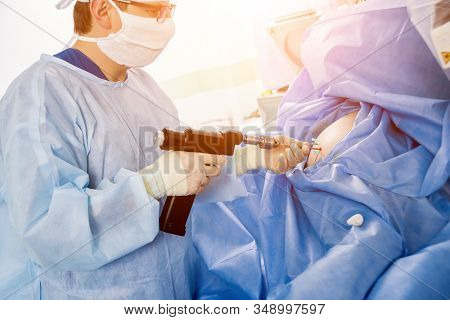 Arthroscope Surgery. Orthopedic Surgeons In Teamwork In The Operating Room