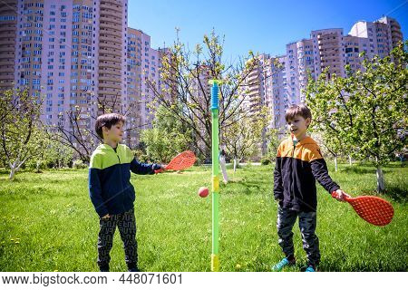 Two Friends Are Playing Tetherball Swing Ball Game In Summer Camping. Two Boy Brother Happy Leisure