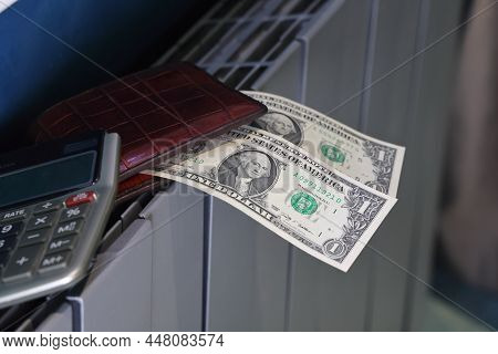 Calculator, Wallet And Banknotes Lie On The Radiator Of The Heating System, The Cost Of Heat, Utilit