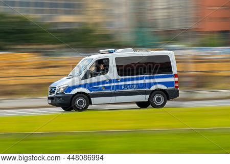 German Police Car With Letters Polizei Drives Fast On Call On The Street. Police Car Hurrying Up On 