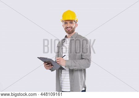 Man Construction Worker Writing In Clipboard Watching In Camera Isolated. Man Builder Working With C